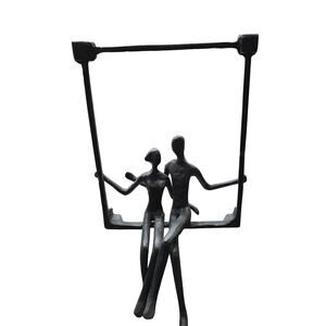 Danya B. Couple Sitting on a Window Sill Iron Wall Hanging